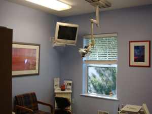 A dental office at Northwood Dental with artwork, flatscreen, and a window.
