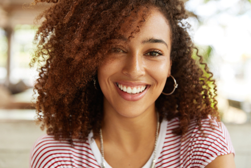 A young woman with beautiful hair smiling