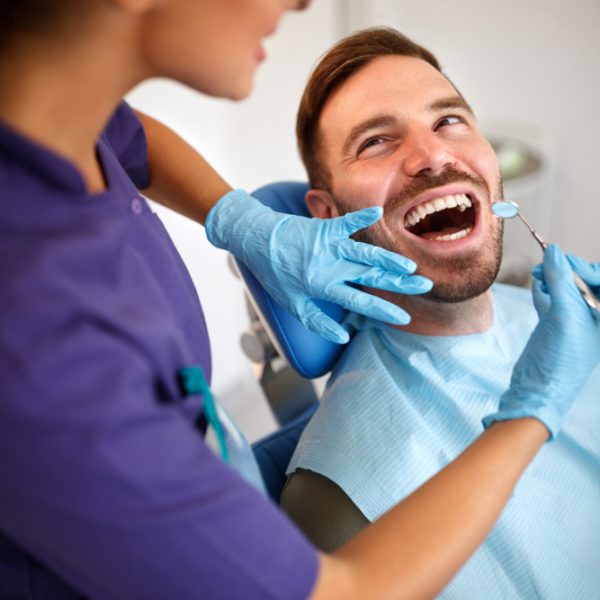 dentist examining man's teeth